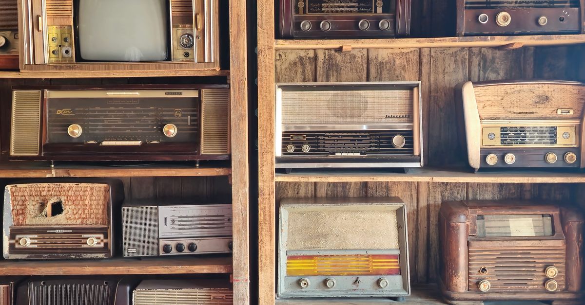 A nostalgic display of vintage radios and retro TV on wooden shelves, capturing timeless charm in Dubai.